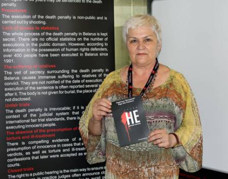 Tamara Chikunova near the stand of the Belarusian human rights defenders against the Vth World Congress against the Death Penalty (Madrid, 2013)