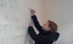 The human rights defender Natallia Mankouskaya leaving a memorial inscription on the office wall
