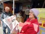 A woman reading the thematic issue of the Narodnaja Volia newspaper at a market in Rečyca. October 7, 2018