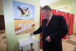 Lukashenka's campaigning poster hangs right over ballot box at precinct where Ulakhovich voted (photo fact)